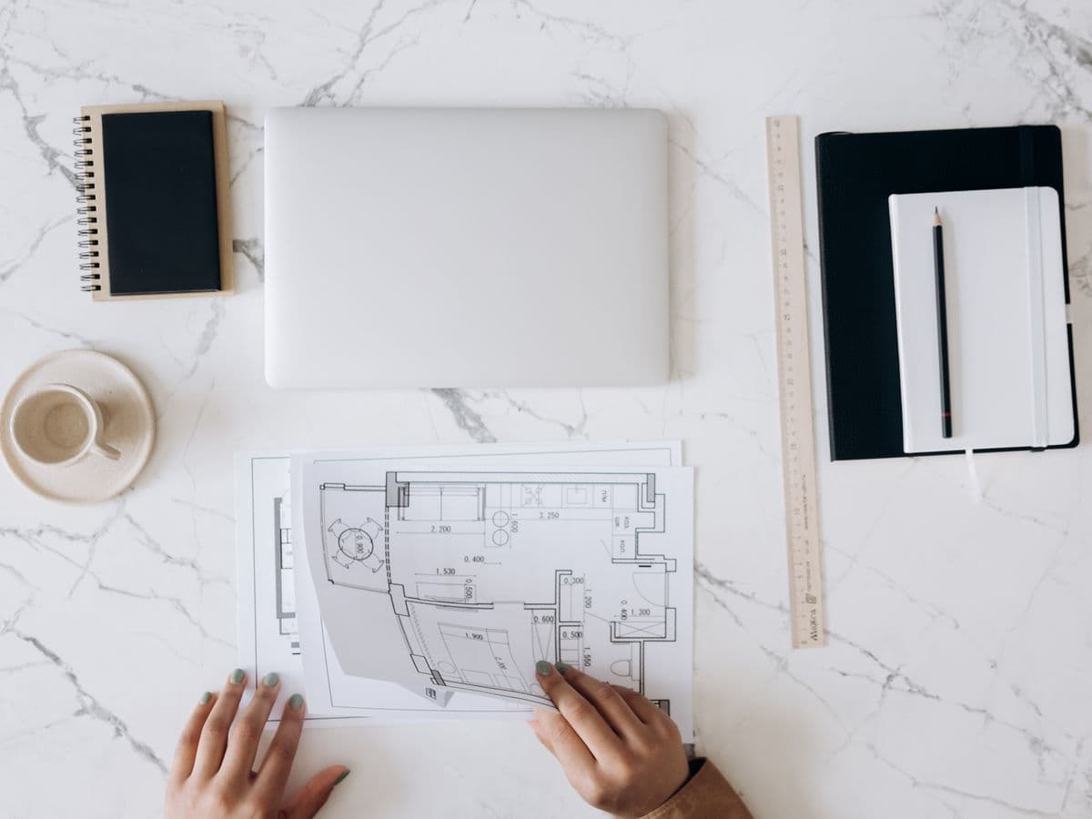 A written retrofit plan and drawings laid out on a work table