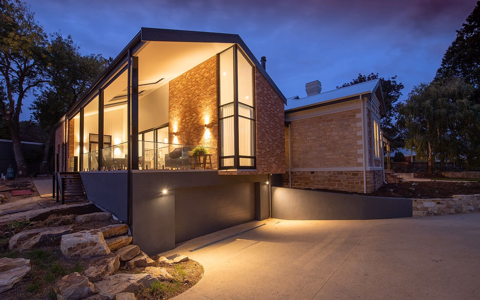 Sun-warmed UK family home at dawn: light cream stone, slate roof, garden wrapping the south side